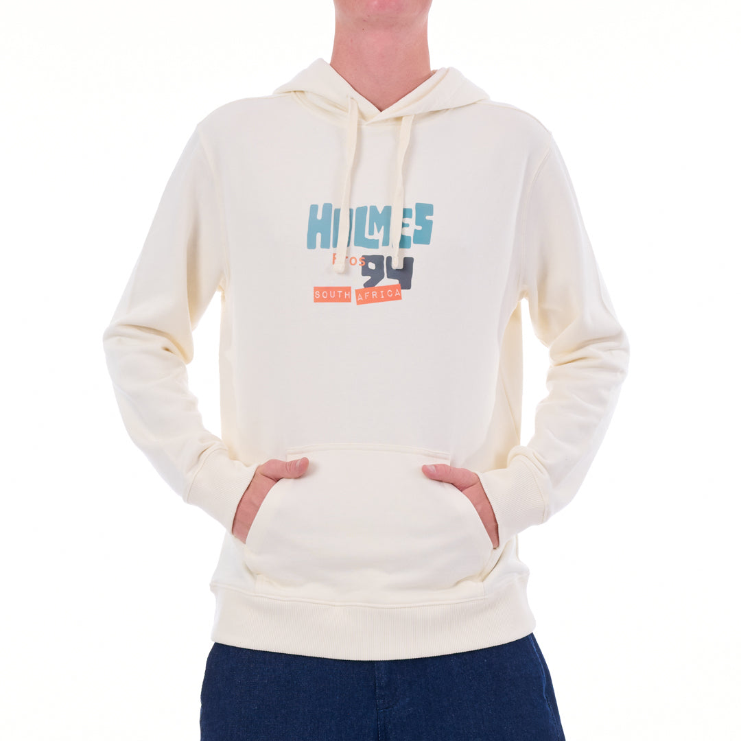 Person wearing a cream hoodie with a logo on a white background
