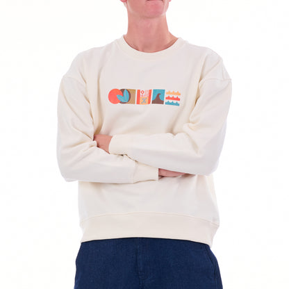 Person wearing a cream sweatshirt with colorful graphics on a white background