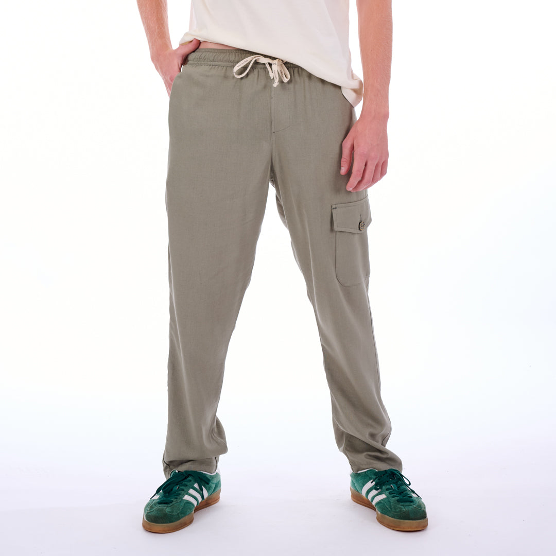 Person wearing beige cargo pants on a white background