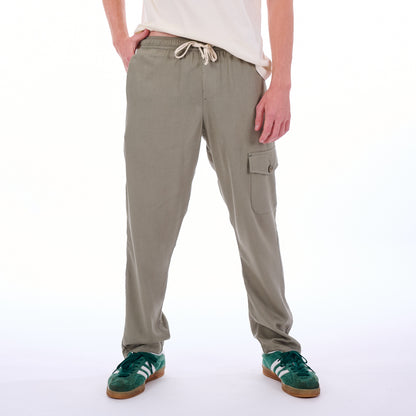 Person wearing beige cargo pants on a white background