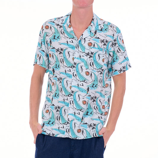 Person wearing a patterned shirt with blue and white design on a white background