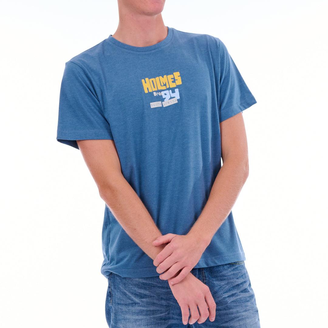 Person wearing a blue t-shirt with 'Holmes' branding on a white background