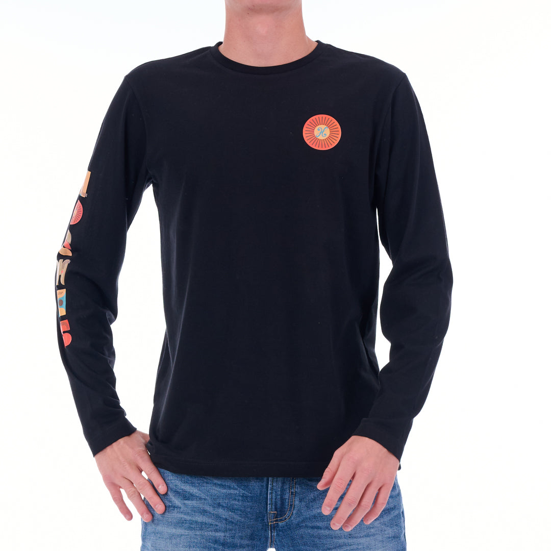 Black long-sleeve shirt with colorful design on sleeve and chest, worn by a person.