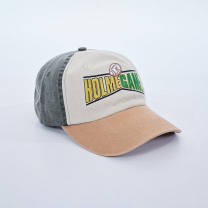 Baseball cap with 'HOLMEGAN' branding on a light gray background