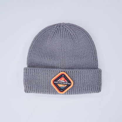 Gray beanie with a Holmesbros patch on a light gray background