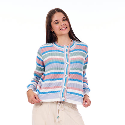 Woman wearing a colorful striped sweater on a white background