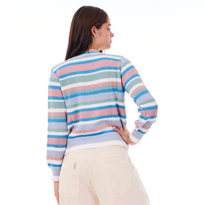 Woman wearing a colorful striped sweater on a white background