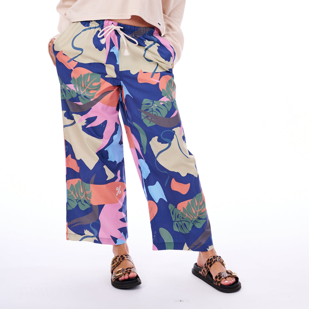 Colorful patterned pants worn by a person on a white background