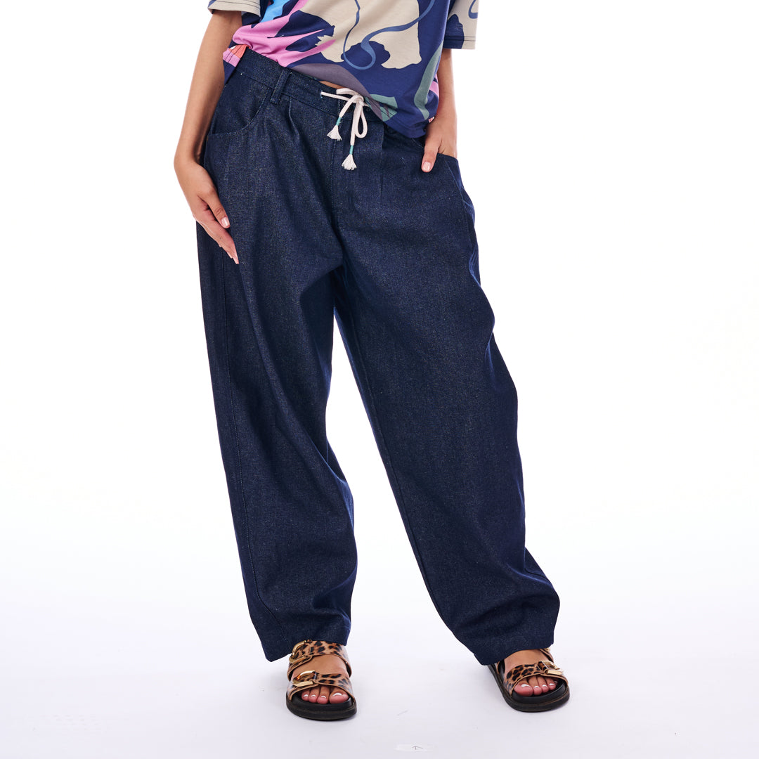 Person wearing blue wide-leg pants on a white background