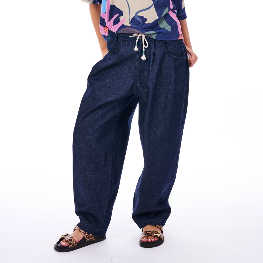 Person wearing blue denim pants on a white background