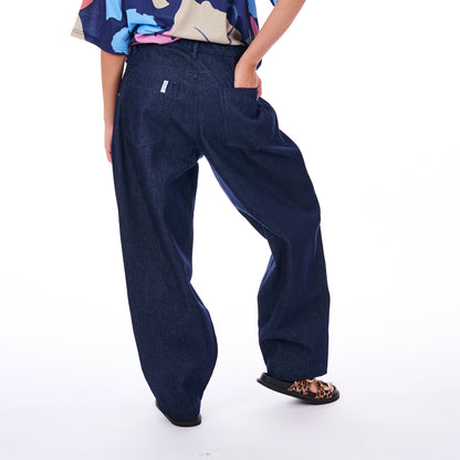 Person wearing blue wide-leg pants on a white background