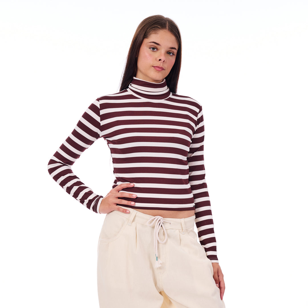 Person wearing a striped long-sleeve top and beige pants on a white background