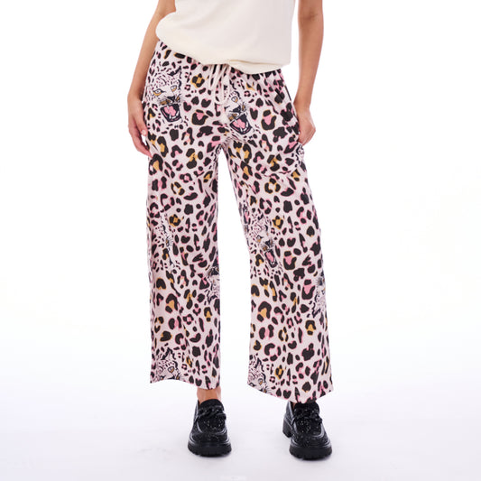 Person wearing leopard print pants on a white background