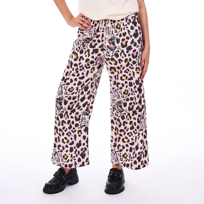Person wearing leopard print pants on a white background